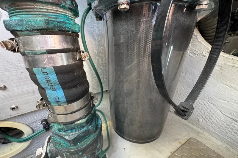 Engine compartment of 2006 Mainship 34 Trawler, showing hose and filter details.