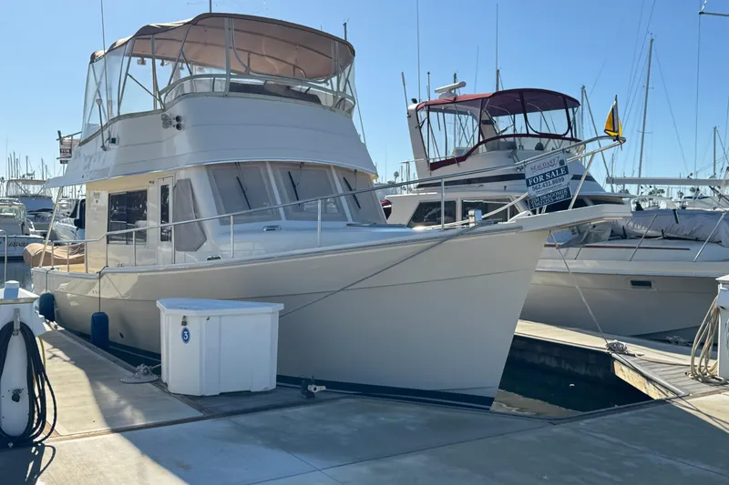 2006 Mainship 34 Trawler docked at marina, available for sale.