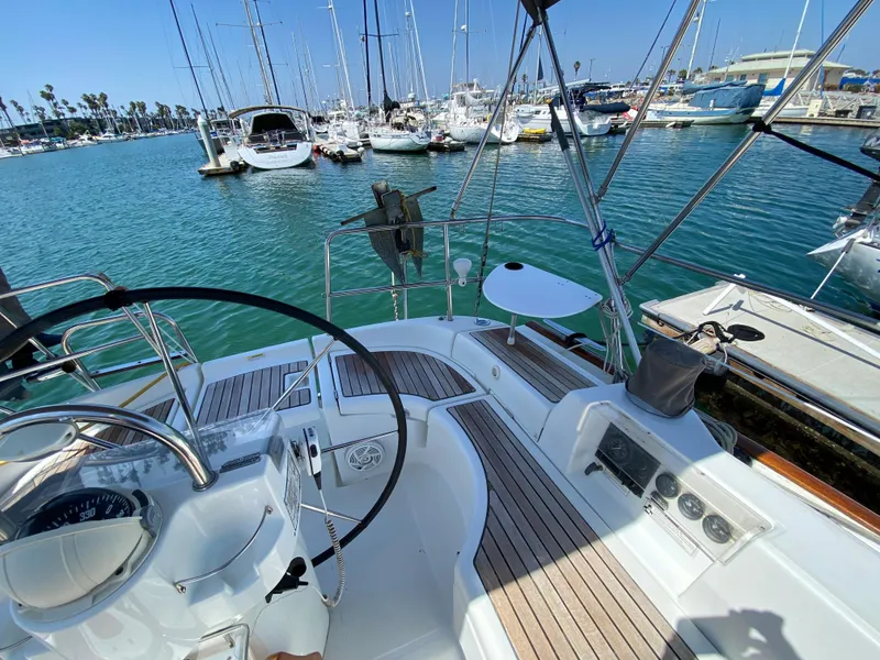 Cockpit view of a 2003 Beneteau 423 sailboat docked in a marina.