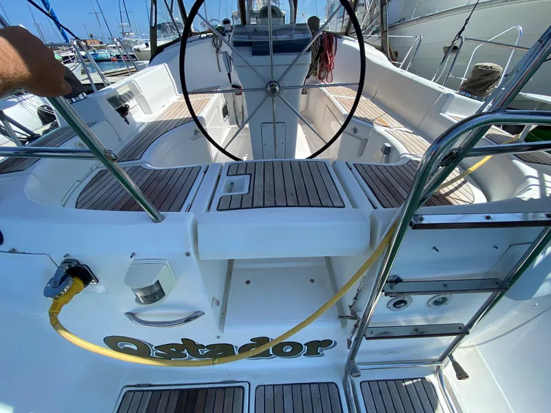 Cockpit of 2003 Beneteau 423 sailboat with teak decking and steering wheel.
