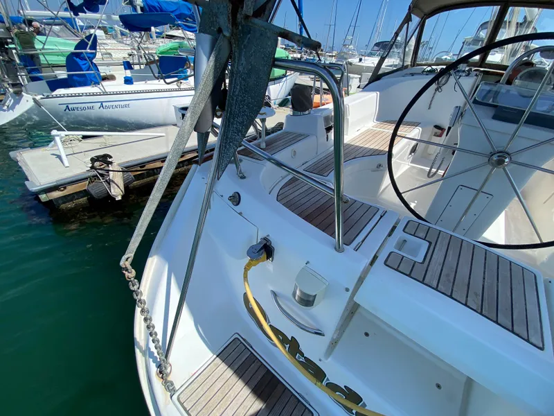 Beneteau 423 sailboat, 2003 model, docked at marina with visible steering wheel and deck.