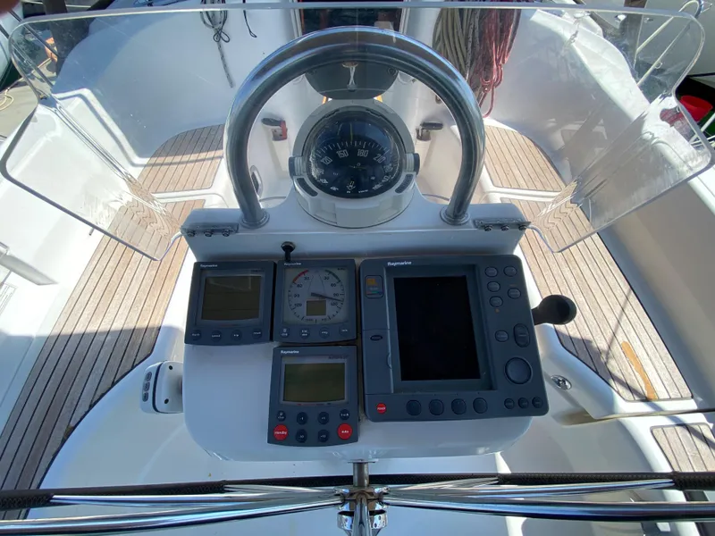 Beneteau 423 2003 sailboat cockpit with navigation instruments and steering wheel.