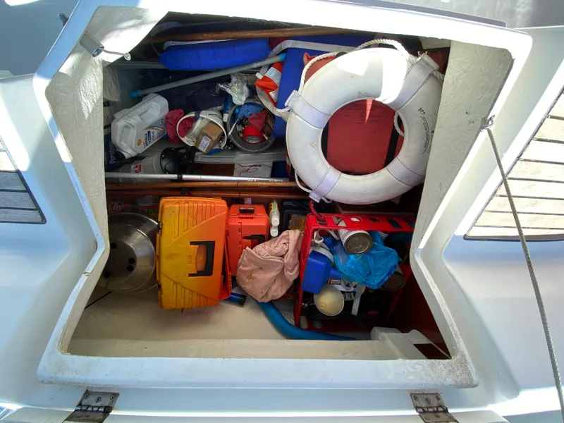 Storage compartment of a 2003 Beneteau 423 sailboat filled with various boating equipment.
