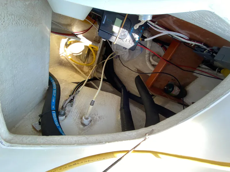 Engine compartment of a 2003 Beneteau 423 sailboat with visible wiring and hoses.