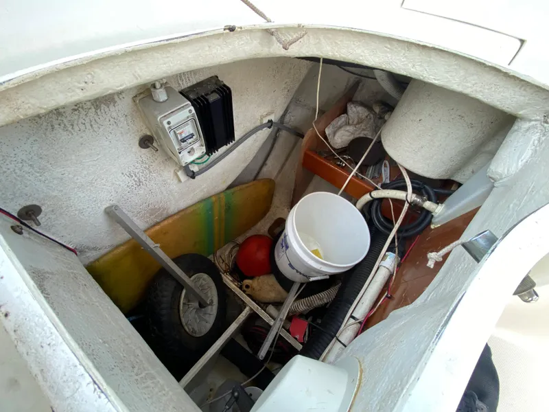 Storage compartment of a 2003 Beneteau 423 sailboat with various equipment.
