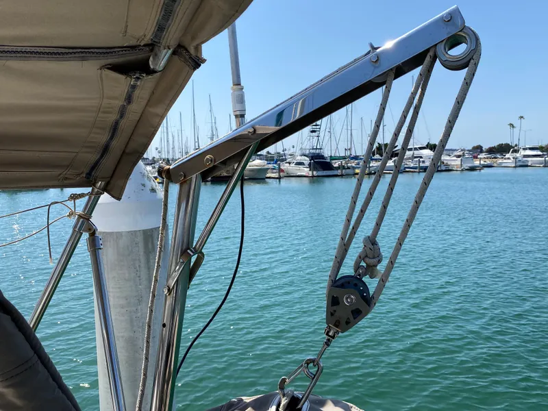 Beneteau 423 sailboat, 2003 model, docked at marina with clear blue water.