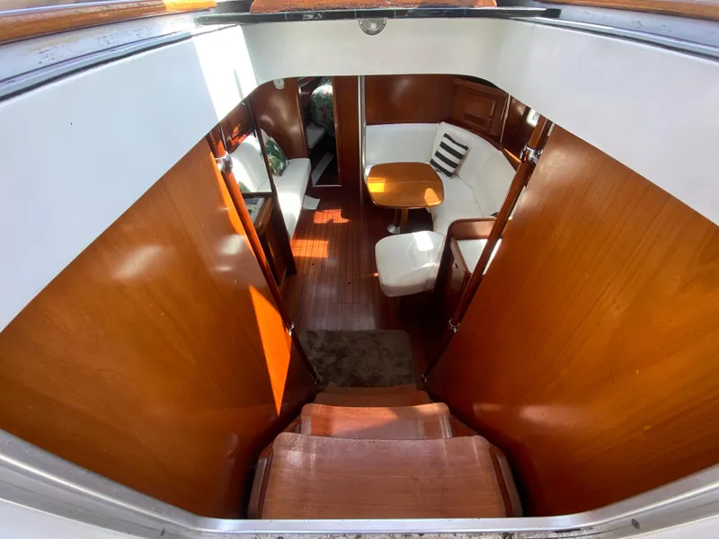Interior of 2003 Beneteau 423 sailboat with wooden finishes and seating area.