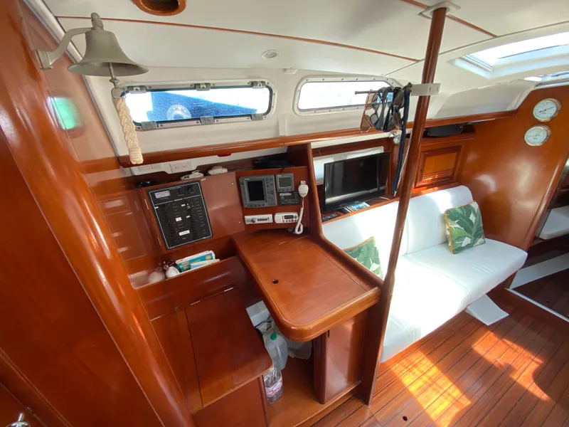 Interior of 2003 Beneteau 423 sailboat with wood finish and navigation equipment.
