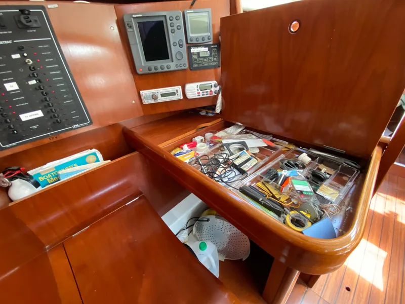Navigation station on a 2003 Beneteau 423 yacht with equipment and organized tools.