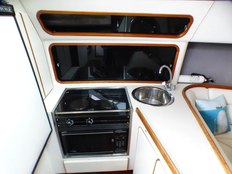 1989 Tiara Yachts 3300 interior kitchen with stove, sink, and modern design.
