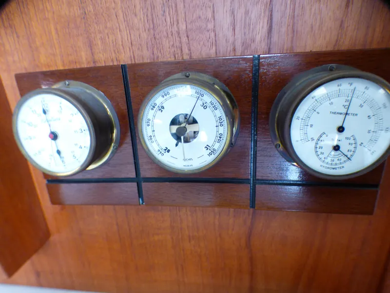 Vintage gauges on 1989 Tiara Yachts 3300 dashboard, featuring temperature and pressure indicators.
