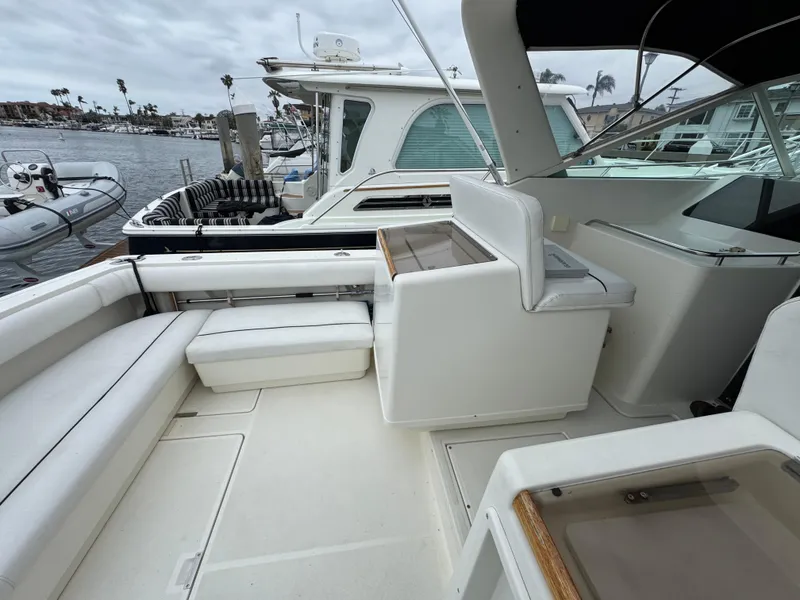 1989 Tiara Yachts 3300 with spacious deck, white seating, and marina view.