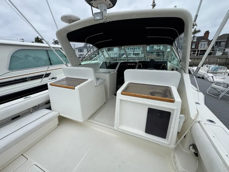 1989 Tiara Yachts 3300 cockpit with seating and helm, docked at marina.