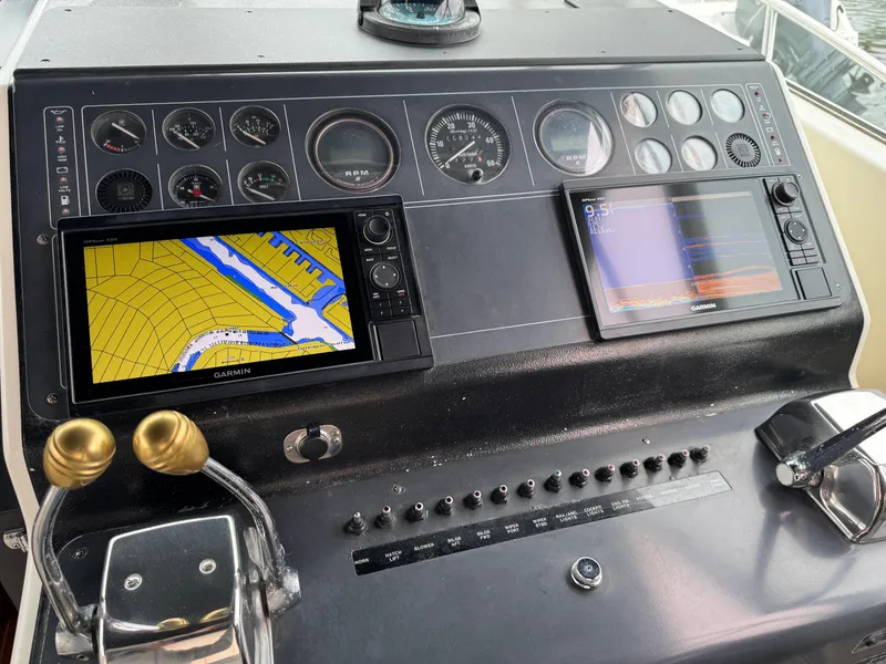 Cockpit of 1989 Tiara Yachts 3300 with navigation screens and controls.
