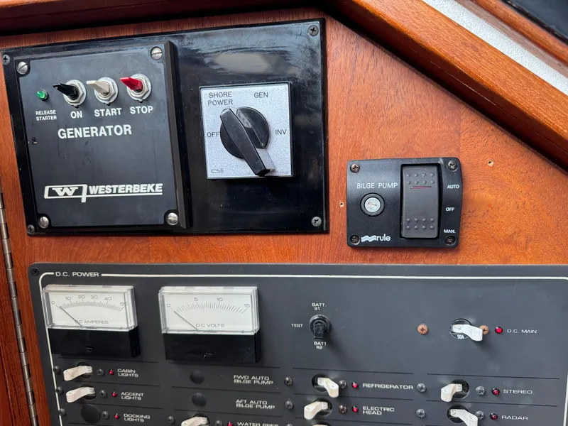 Control panel of a 1989 Tiara Yachts 3300, featuring generator and bilge pump switches.