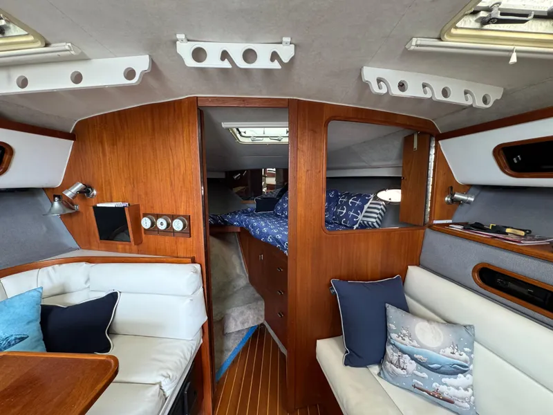 1989 Tiara Yachts 3300 interior with cozy seating and wooden accents.
