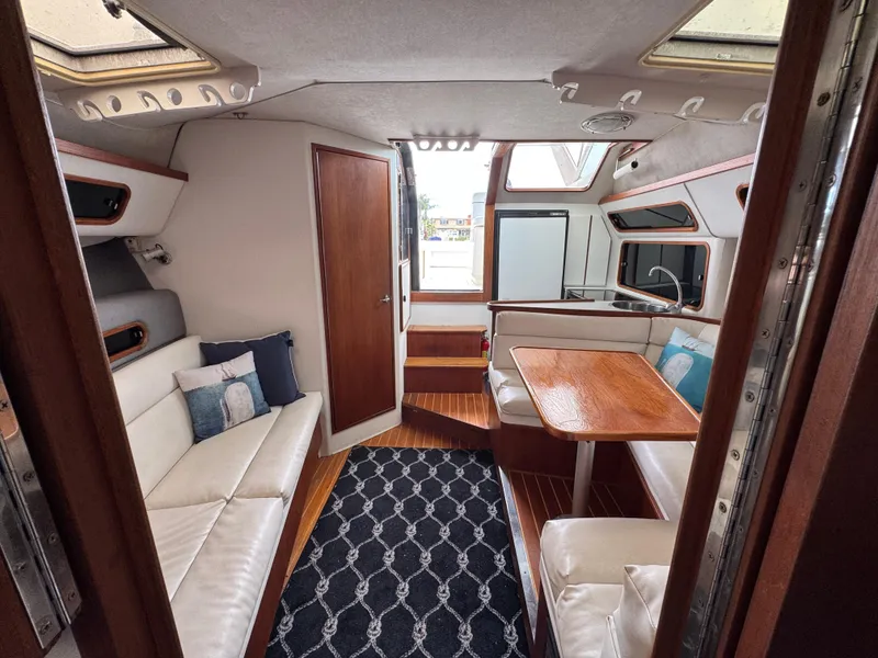 1989 Tiara Yachts 3300 interior with seating, table, and modern decor.