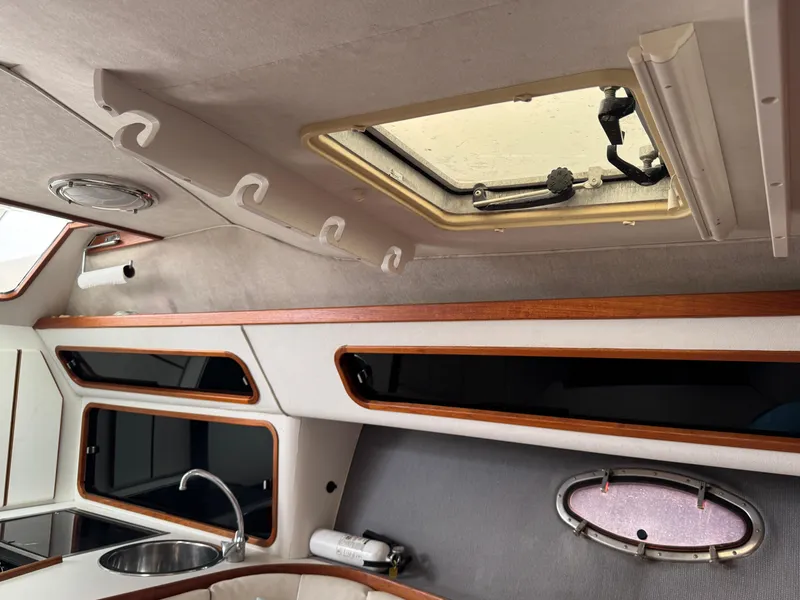 Interior of a 1989 Tiara Yachts 3300, featuring a skylight and wooden accents.