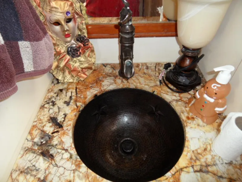 Custom Bronze sinks and sink fixtures throughout