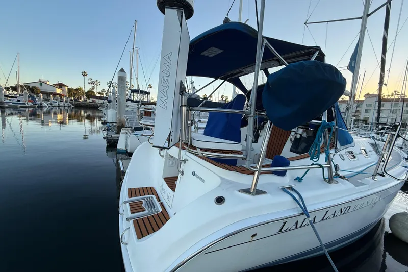 Hunter 31 sailboat from 2007 docked in a marina at sunset.