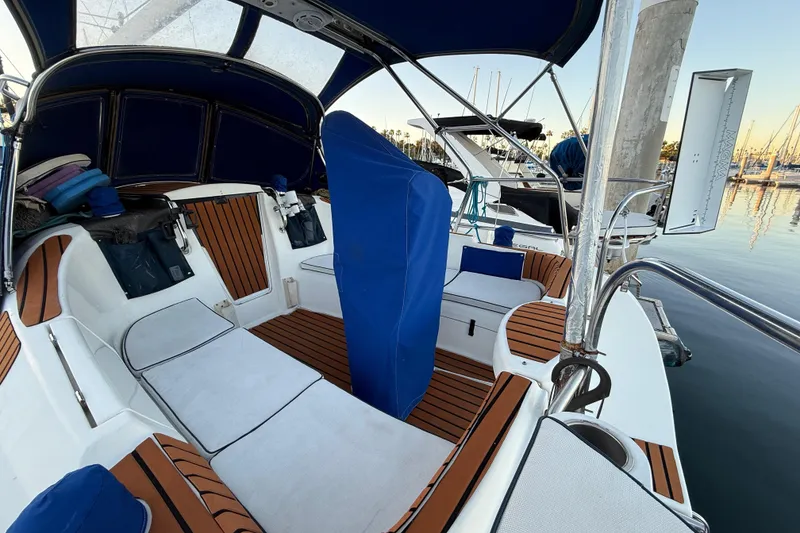 Cockpit of a 2007 Hunter 31 sailboat with cushioned seating and blue canopy.