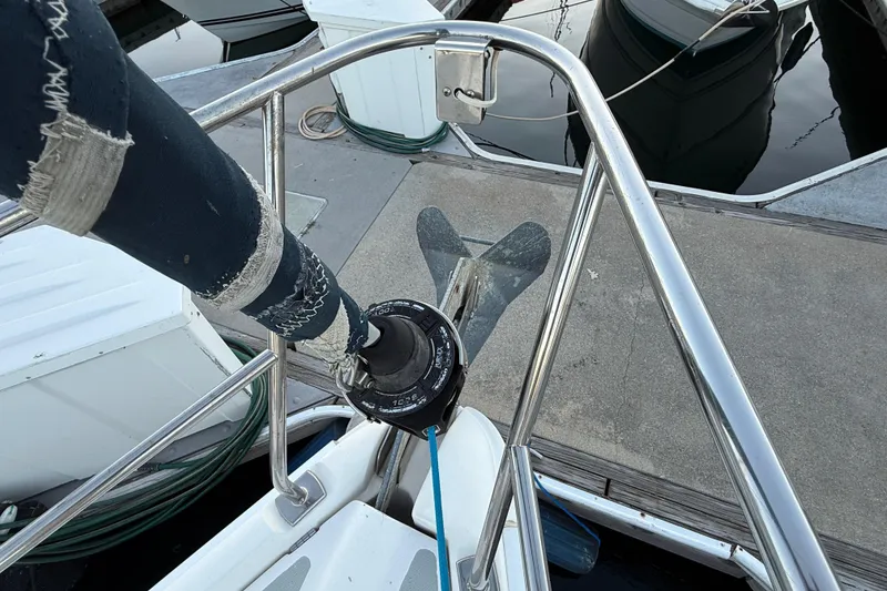 Bow view of a 2007 Hunter 31 sailboat docked, showing anchor and railing.
