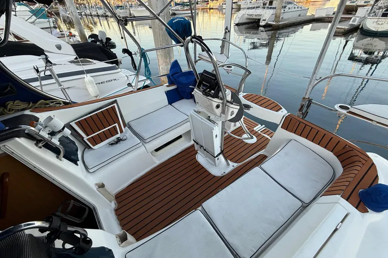 Cockpit of 2007 Hunter 31 sailboat with teak flooring and marina view.