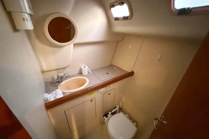 2007 Hunter 31 yacht bathroom with sink, mirror, and toilet.