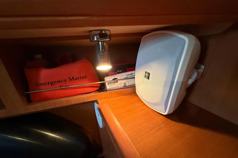 2007 Hunter 31 interior with emergency marine kit and speaker.