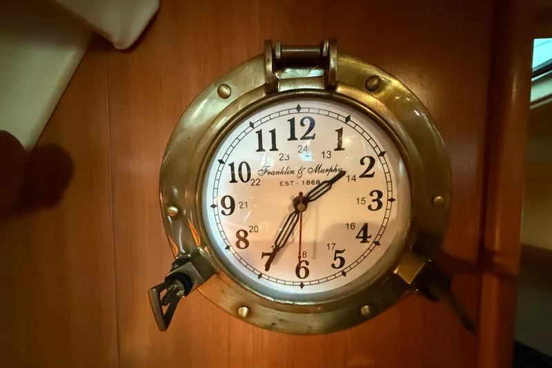 Brass nautical clock on 2007 Hunter 31 sailboat interior wall.