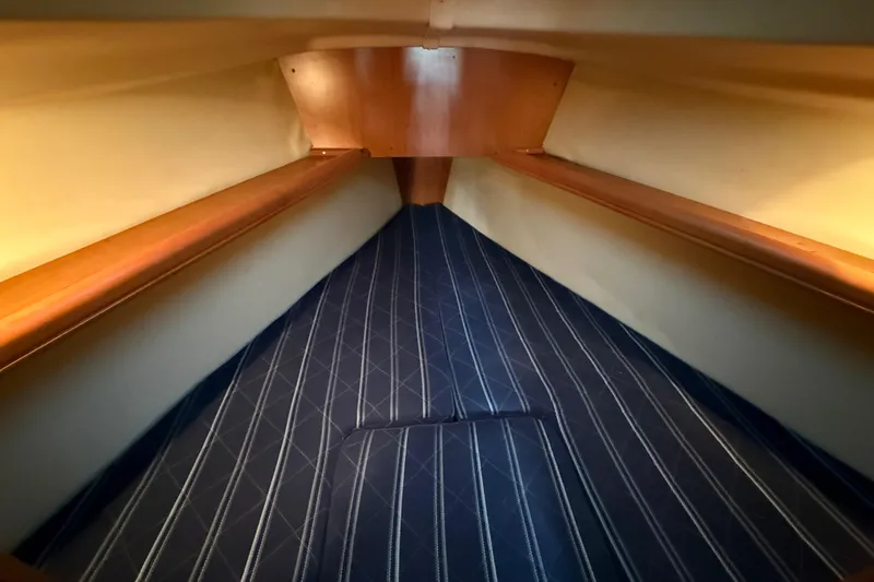 2007 Hunter 31 sailboat interior with striped upholstery and wooden accents.