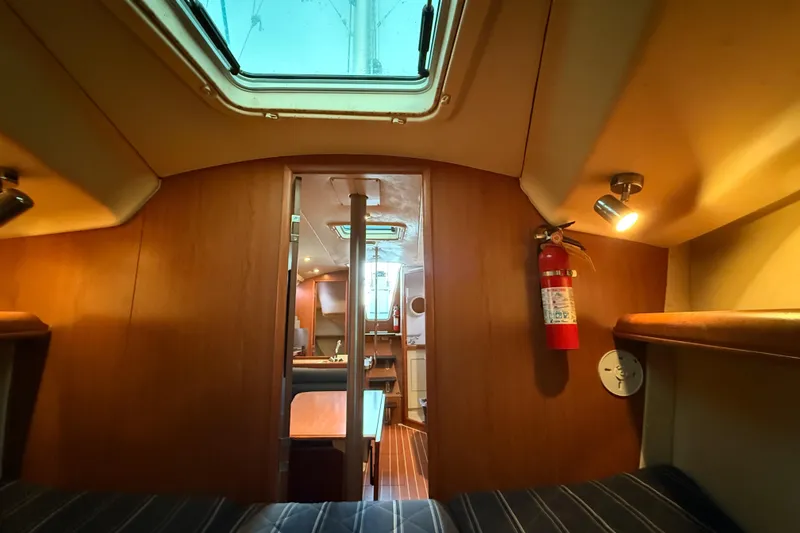 Interior of a 2007 Hunter 31 sailboat, featuring cozy cabin and wooden finishes.