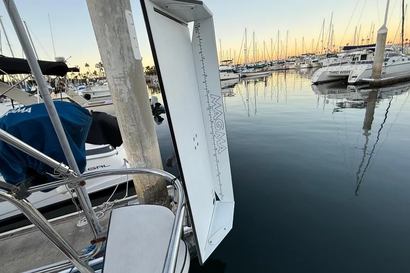 Marina with Hunter 31 sailboat, 2007 model, docked at sunset with calm waters.