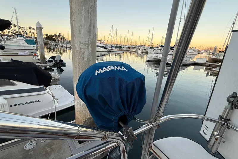 Marina view with boats, featuring a 2007 Hunter 31 sailboat and Magma grill cover.