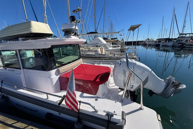 2022 Axopar 28 AFT CABIN boat docked in marina with American flag.