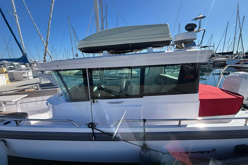2022 Axopar 28 AFT CABIN boat docked at marina, side view.
