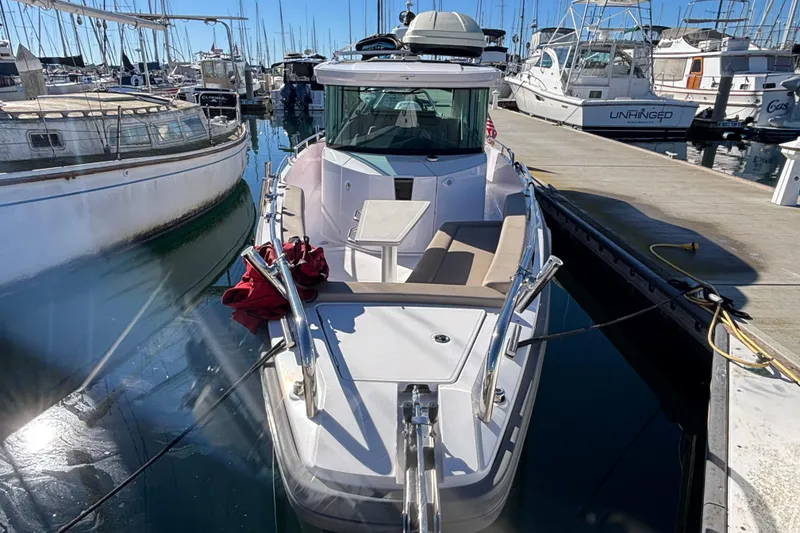 2022 Axopar 28 AFT CABIN boat docked at marina, surrounded by other vessels.