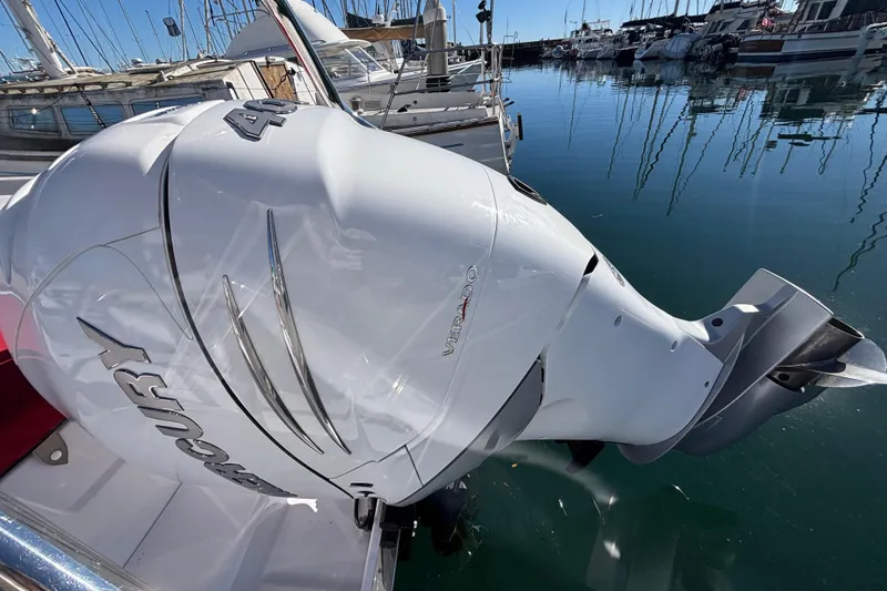 Outboard motor on 2022 Axopar 28 AFT CABIN boat, docked in marina.