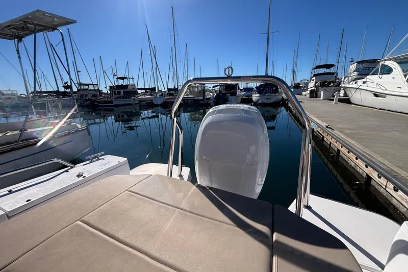 2022 Axopar 28 AFT CABIN boat docked in a marina under clear blue skies.