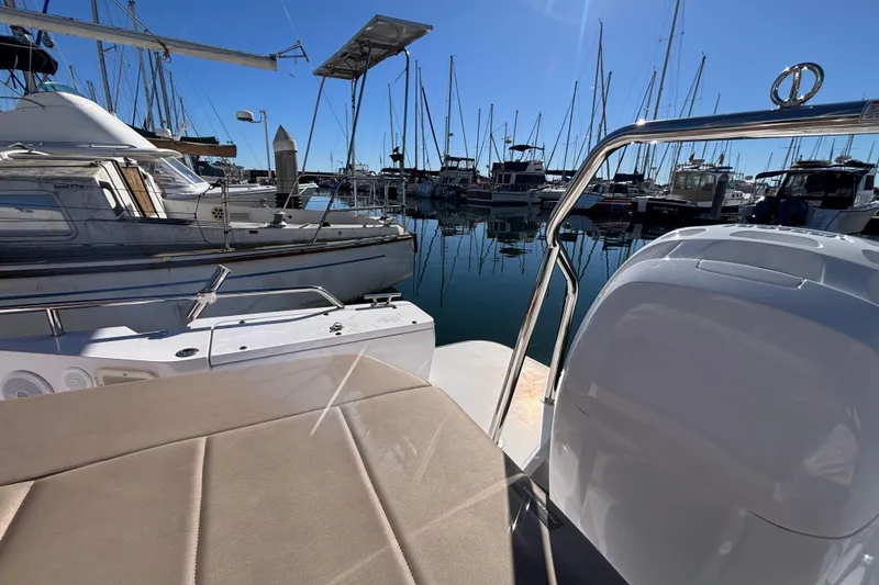 2022 Axopar 28 AFT CABIN boat docked in a marina with clear blue sky.