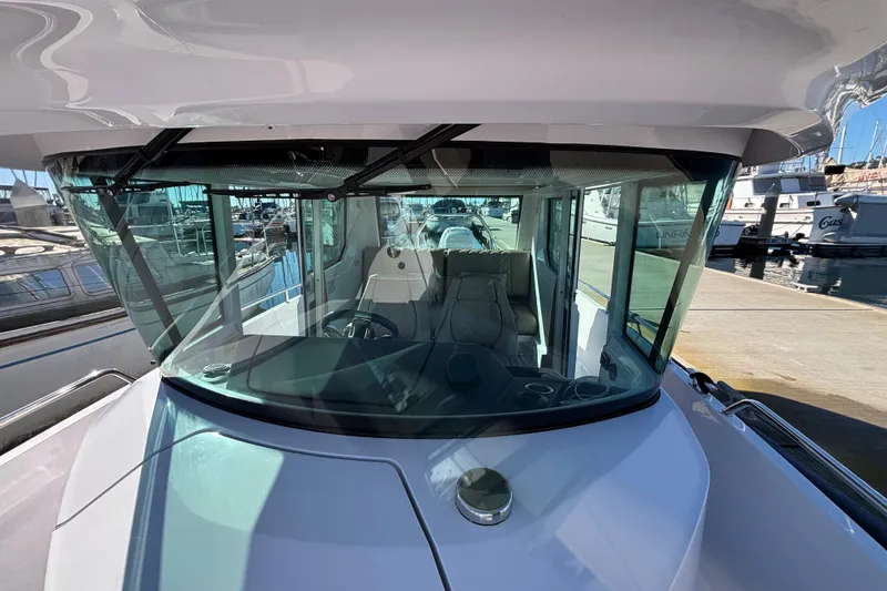 2022 Axopar 28 AFT CABIN boat, docked, showcasing sleek design and spacious cabin.