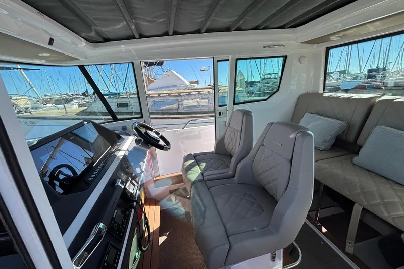 Interior of 2022 Axopar 28 AFT CABIN with modern seating and dashboard.