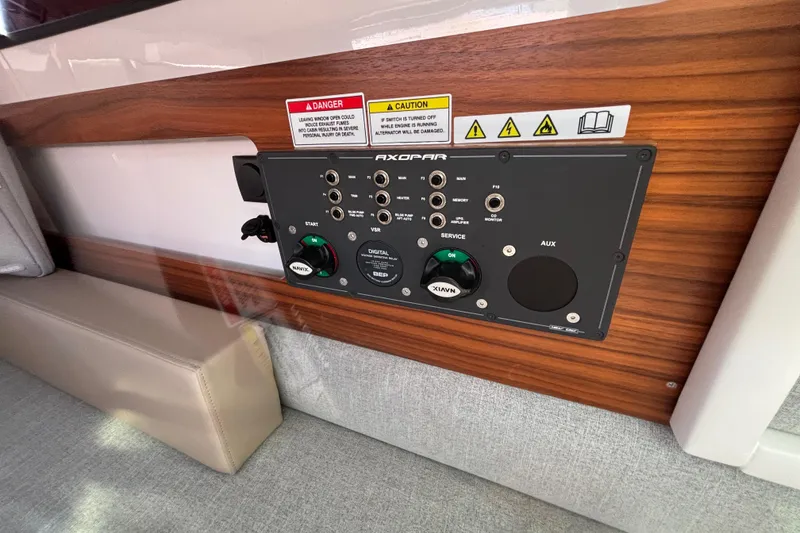 Control panel in 2022 Axopar 28 AFT CABIN, featuring various switches and indicators.