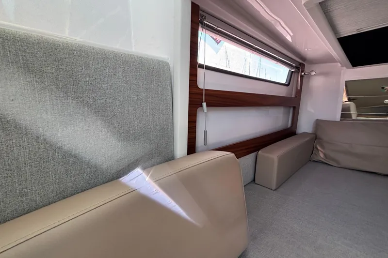 Interior of 2022 Axopar 28 AFT CABIN with modern seating and window design.