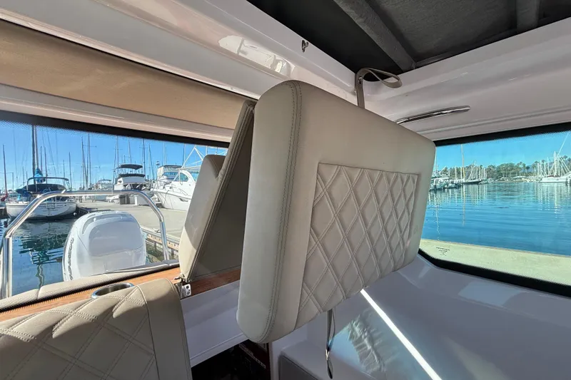 Interior view of 2022 Axopar 28 AFT CABIN with marina backdrop.
