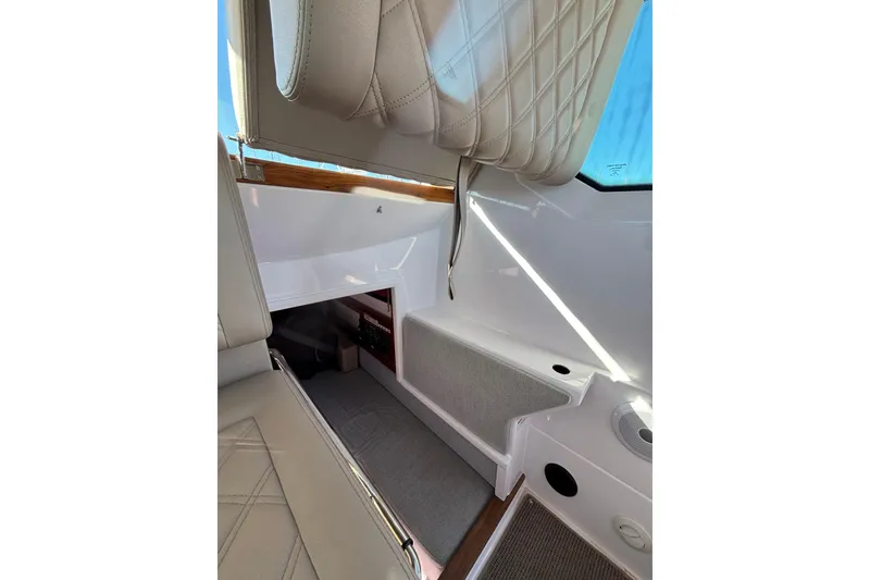 Interior of 2022 Axopar 28 AFT CABIN, featuring modern seating and sleek design elements.