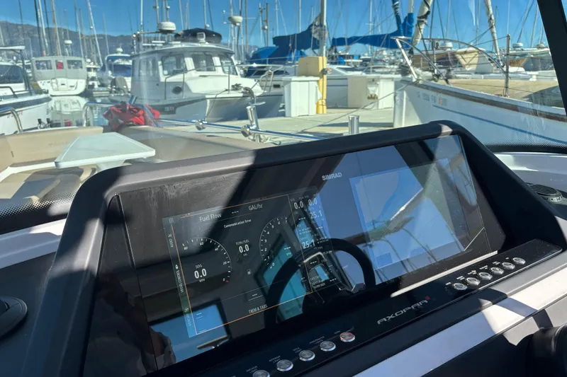 2022 Axopar 28 AFT CABIN dashboard with Simrad display in marina setting.