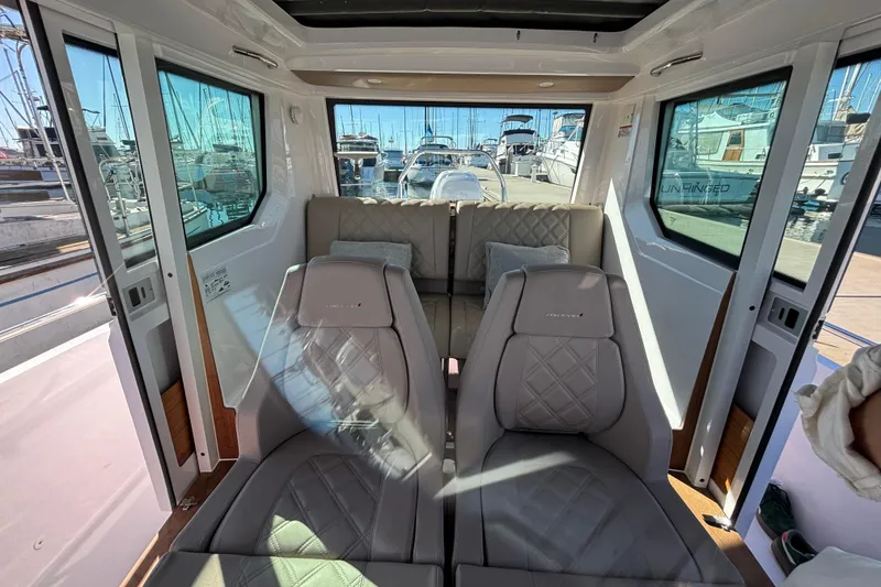 Interior of 2022 Axopar 28 AFT CABIN, featuring luxurious seating and panoramic windows.