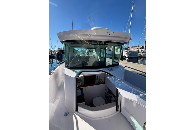 2022 Axopar 28 AFT CABIN boat docked at marina, showcasing sleek design and cabin entrance.