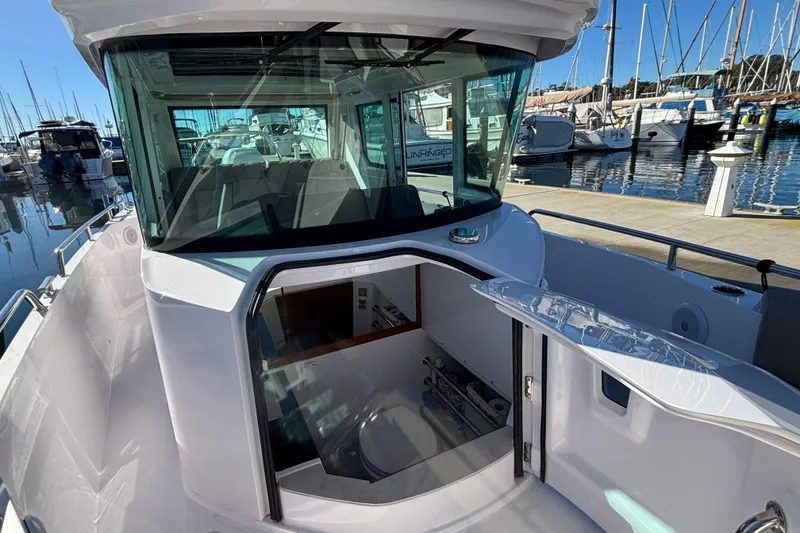 2022 Axopar 28 AFT CABIN boat docked at marina, showcasing cabin entrance.